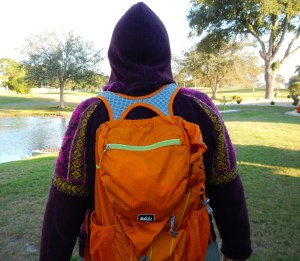 maroon hooded sweater with orange knapsack